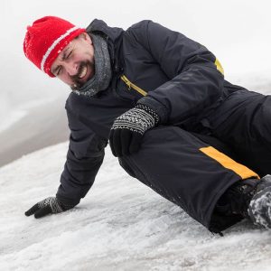 man grimacing after slipping and falling on the ice