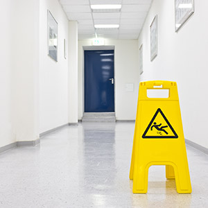 caution wet floor sign in empty hallway