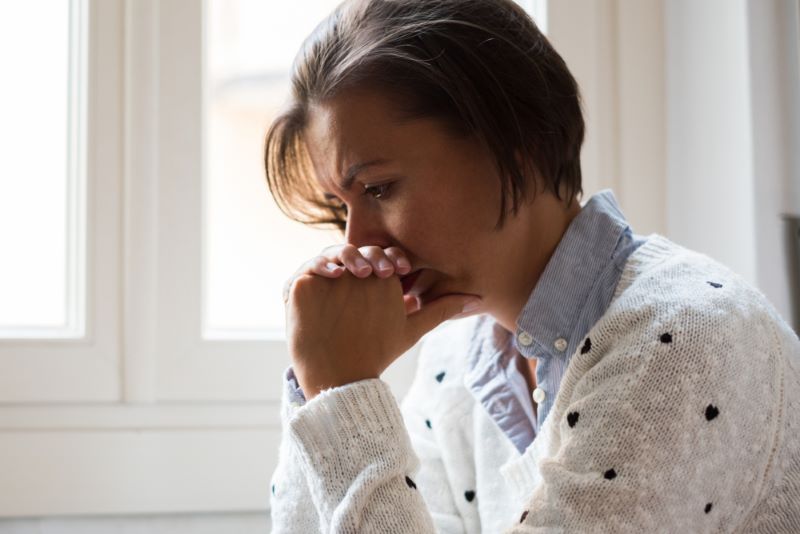 sad woman calculating wrongful death settlement