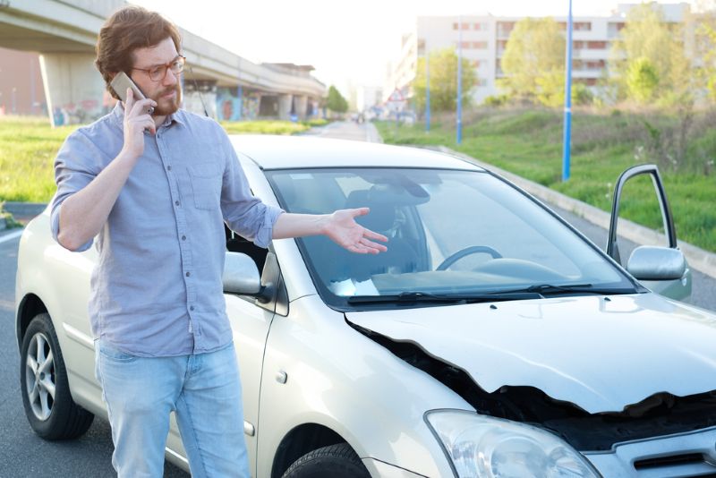 man on the phone after a car accident
