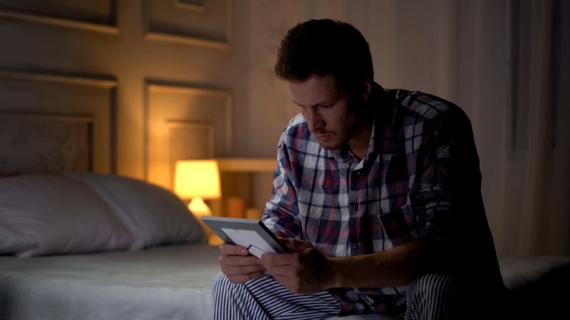 lonely man looking at a picture of his wife