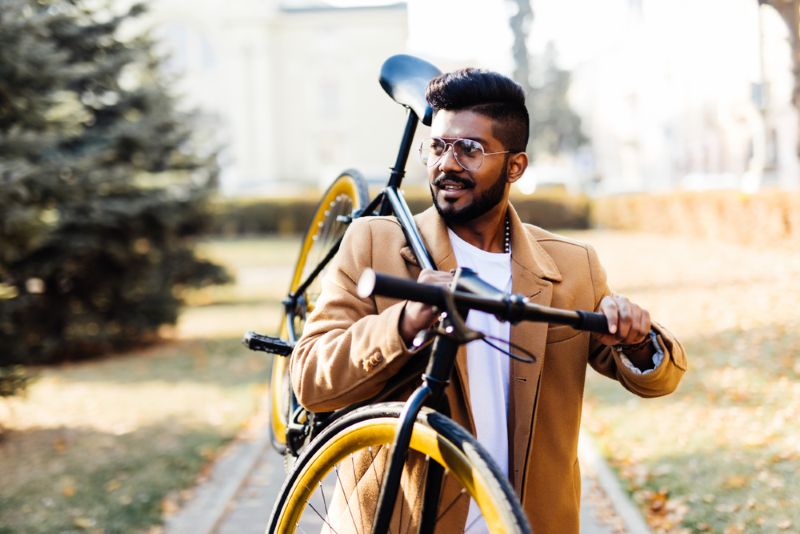 man carrying his bike to go on a ride