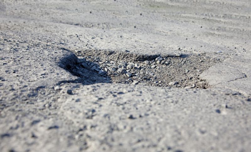 big pothole in the middle of the road