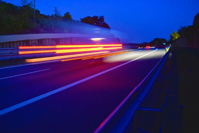 time lapsed photo of a truck driving on the highway