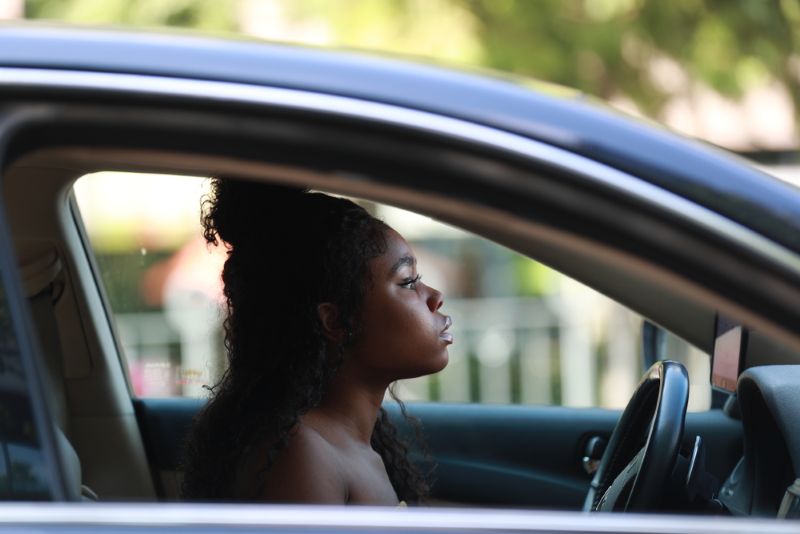 a woman looking out of a car window