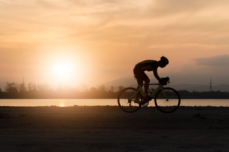 experienced cyclist riding at sunset