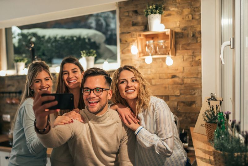 group of friend posing for a picture together inside