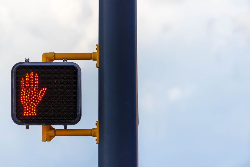 walking sign with a bright red hand