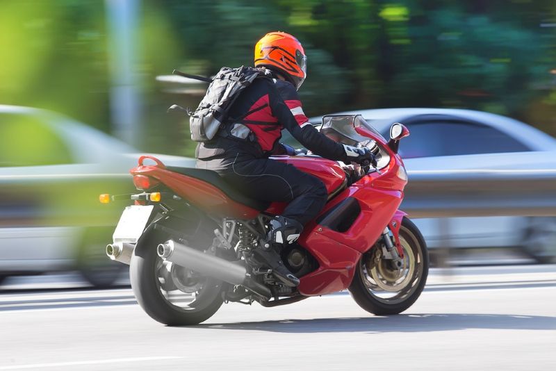 Riding a motorcycle on a busy street