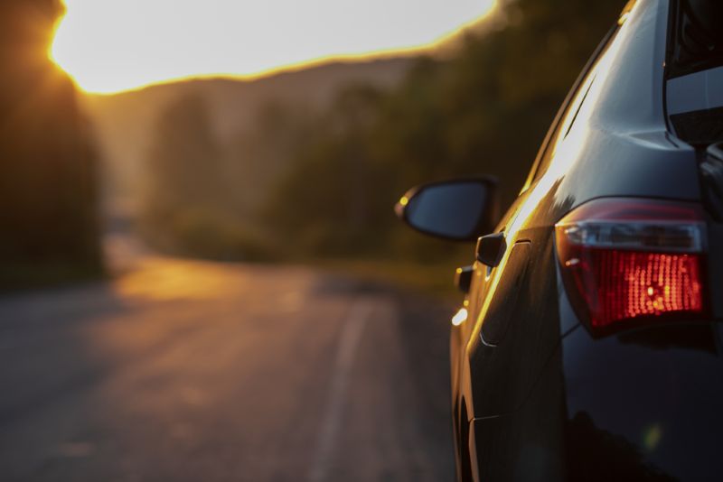 Car pulled over to the side of the road during sunset