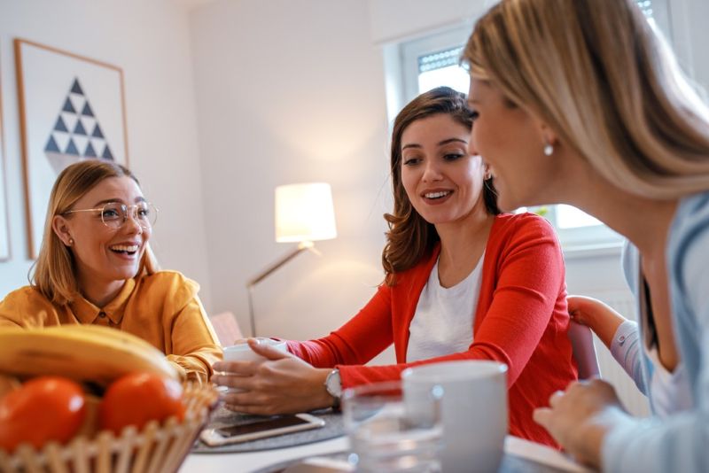Group of women friends hanging out together at home