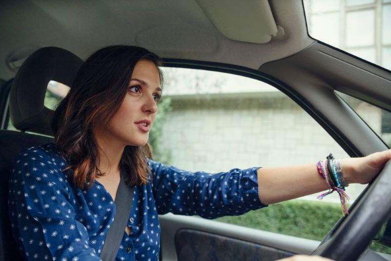 Woman driving her car attentively during the day