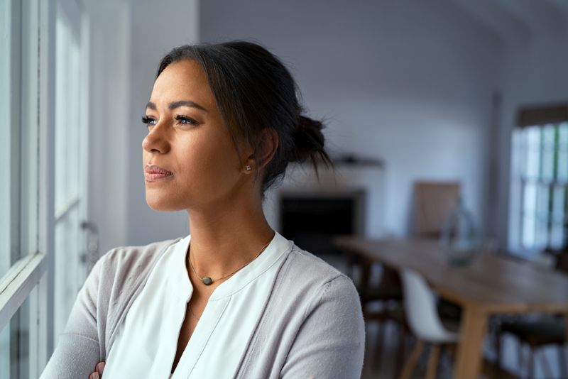 Young woman looking intently out the window