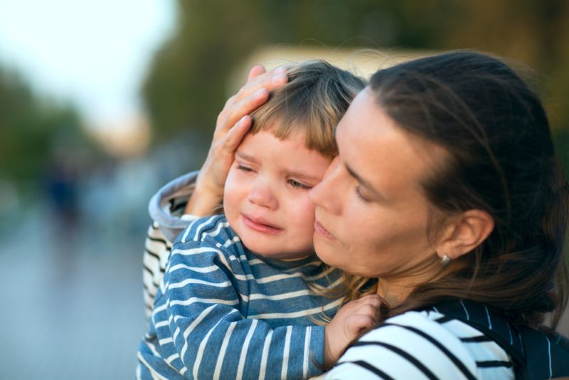 Sad mother holding her crying baby close