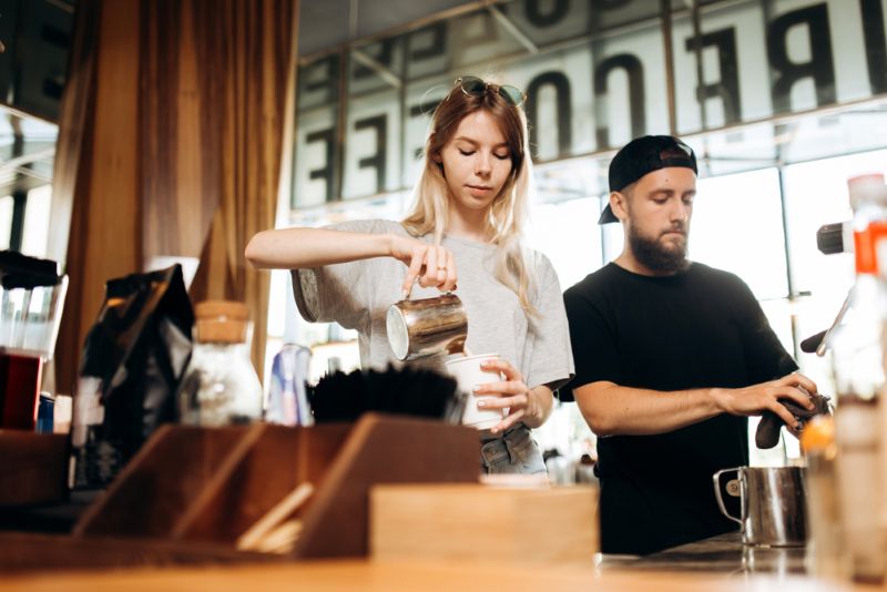 Baristas making drinks in a cafe