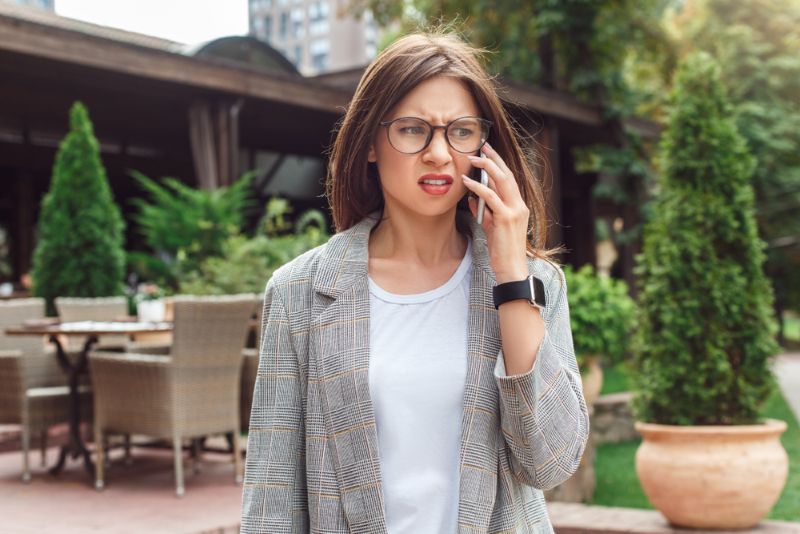 Unhappy woman taking a phone call